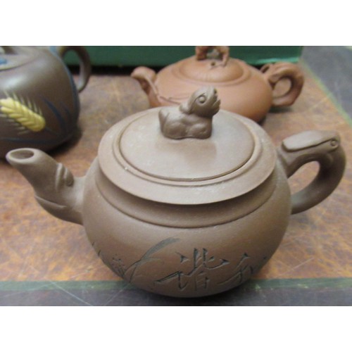 854 - Four various small Chinese terracotta teapots, two saucer dishes, a crackleware dish and four ladles... 