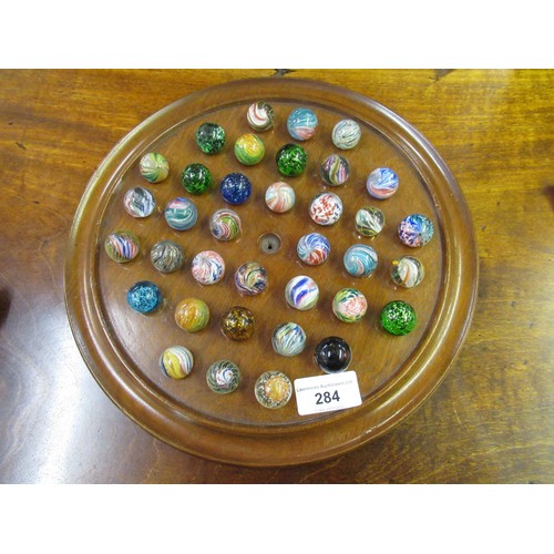 284 - Solitaire board and a collection of antique marbles