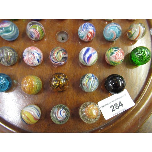 284 - Solitaire board and a collection of antique marbles