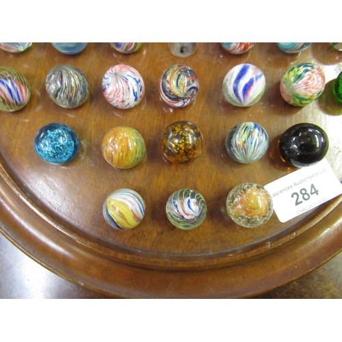 284 - Solitaire board and a collection of antique marbles