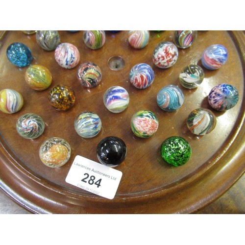 284 - Solitaire board and a collection of antique marbles