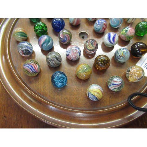 284 - Solitaire board and a collection of antique marbles