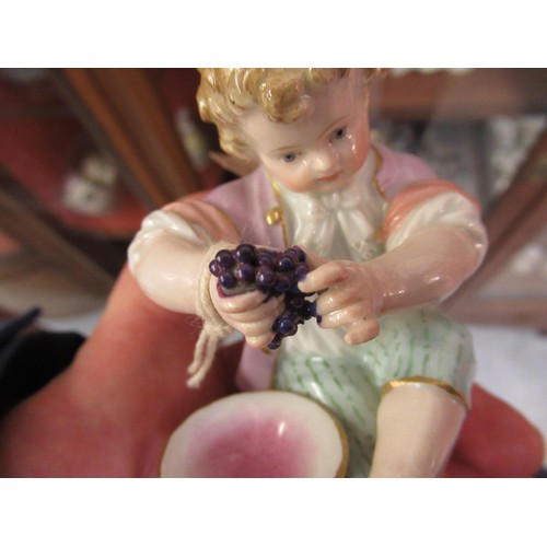 736 - Meissen figure of a seated boy, holding grapes, (two small chips to base) 4.25ins high, together wit... 