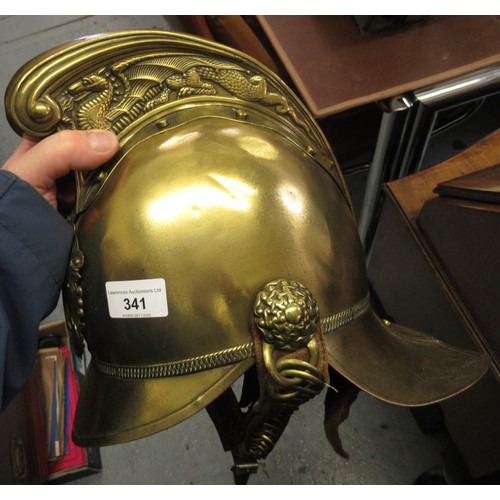 341 - 19th Century brass firemans helmet with crossed axes and hose emblem and original lining (with repai... 