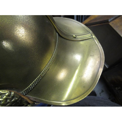 341 - 19th Century brass firemans helmet with crossed axes and hose emblem and original lining (with repai... 