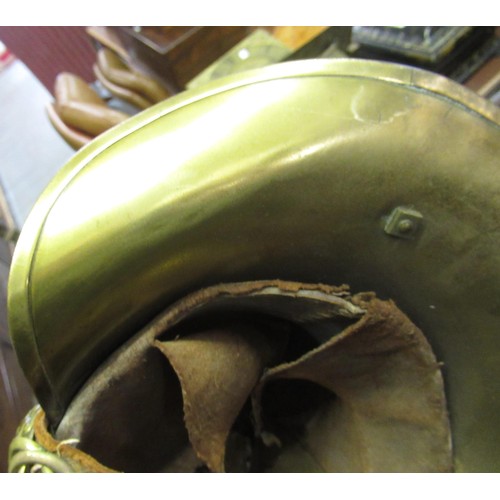 341 - 19th Century brass firemans helmet with crossed axes and hose emblem and original lining (with repai... 