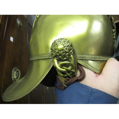 341 - 19th Century brass firemans helmet with crossed axes and hose emblem and original lining (with repai... 