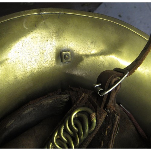 341 - 19th Century brass firemans helmet with crossed axes and hose emblem and original lining (with repai... 