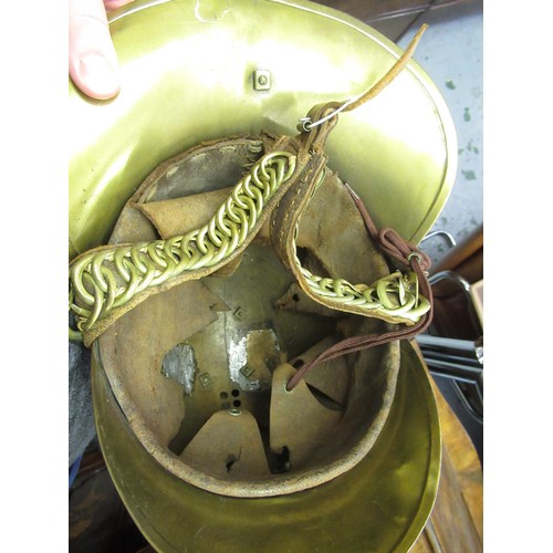 341 - 19th Century brass firemans helmet with crossed axes and hose emblem and original lining (with repai... 