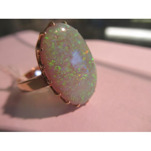 1140 - 9ct Gold ring set large oval opal of good colour, approximately 21 x 14mm overall, size 'R'