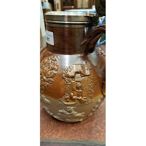 681 - 19th Century salt glazed hunting jug with relief moulded decoration and a silver cover with hinged l... 