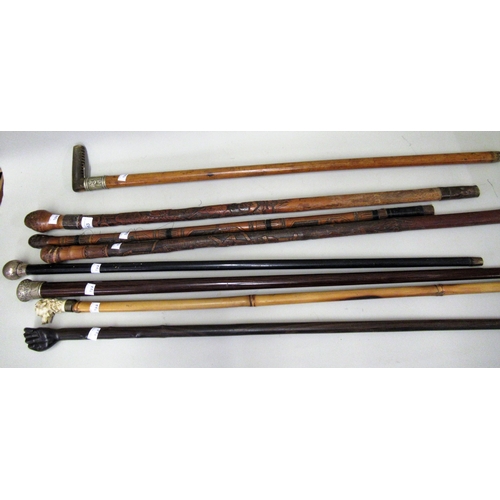 153 - Three various Japanese carved bamboo walking sticks, another with a composition dog's head handle an... 