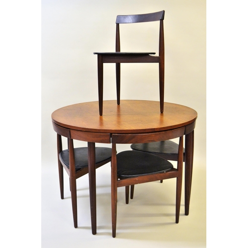 1740 - Frem Rojle, Danish teak circular dining table with four integral chairs on turned tapering supports,... 