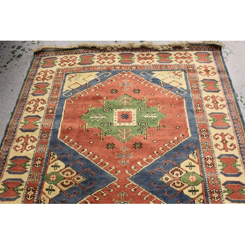 18 - Modern Turkish rug with a twin medallion design in shades of pink, green and blue, 249cms x 174cms a... 