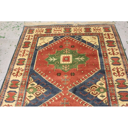 18 - Modern Turkish rug with a twin medallion design in shades of pink, green and blue, 249cms x 174cms a... 