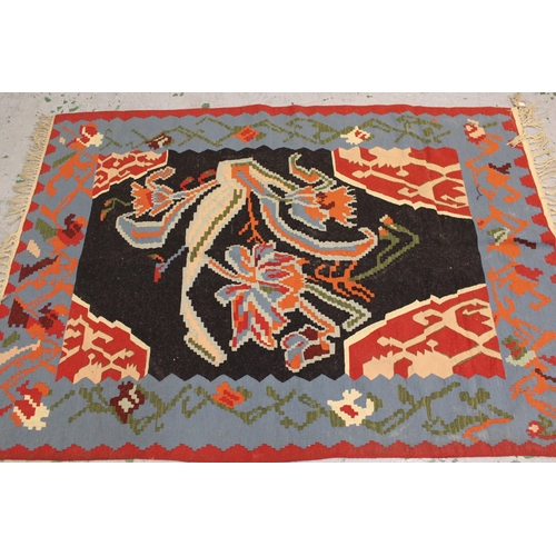 22 - Modern Turkish Kelim rug with a stylised floral design on a black ground with borders, 2.6 x 1.7m