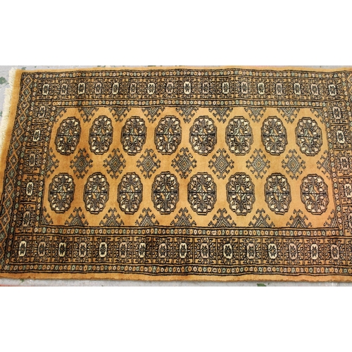 27 - Small Pakistan Bokhara design rug with pink ground, 128cms x 76cms together with a similar, smaller ... 