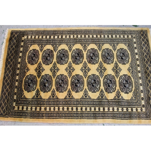 28 - Small Pakistan Bokhara design rug with a single row of gols on a beige ground, 117cms x 80cms togeth... 