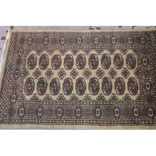 29 - Pakistan Bokhara design rug with two rows of gols on a beige ground, 125cms x 82cms, together with a... 