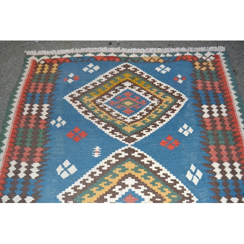 3 - Kelim rug with a triple medallion design on pale blue ground with borders, 213cms x 137cms approxima... 