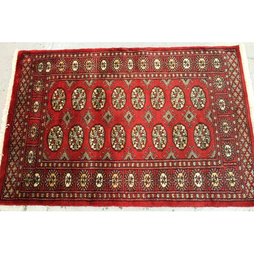 30 - Small Pakistan Bokhara rug with a single row of gols on a blue ground, 125cms x 80cms, together with... 