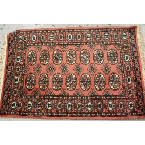 32 - Small Pakistan Bokhara design rug with a single row of gols on a beige ground, 194cms x 65cms togeth... 