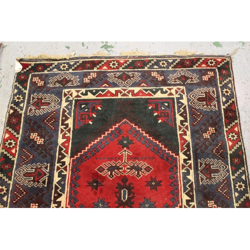 35 - Modern Turkish rug with a twin medallion design in shades of dark blue and red, 180cms x 124cms