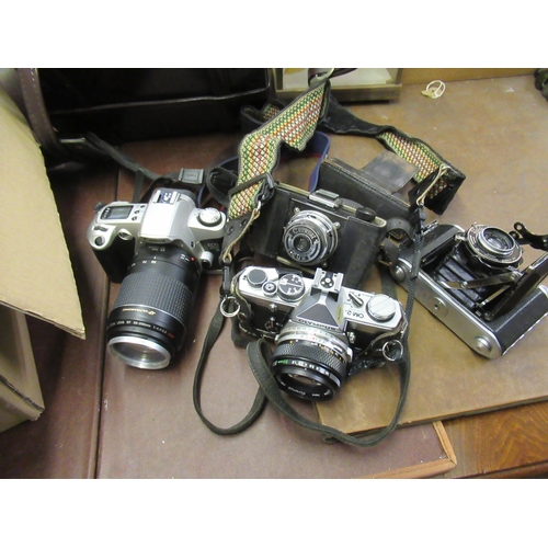 359 - Olympus OM2 SLR camera with extra lens and accessories and a quantity of various other cameras, case... 