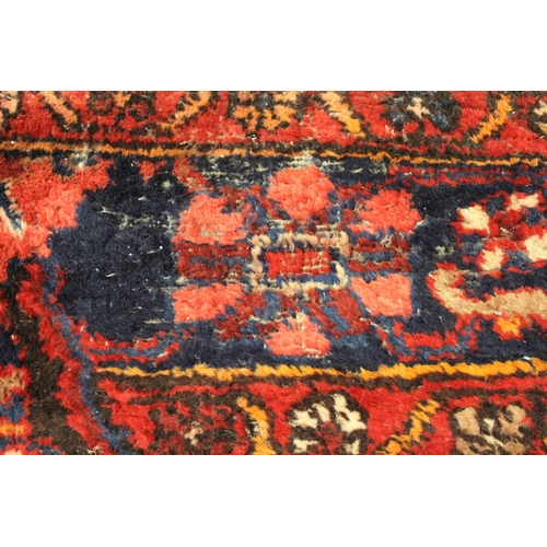 41 - Sarouk runner with a multiple vase and floral design on a dark blue ground with borders, 391 x 110cm... 