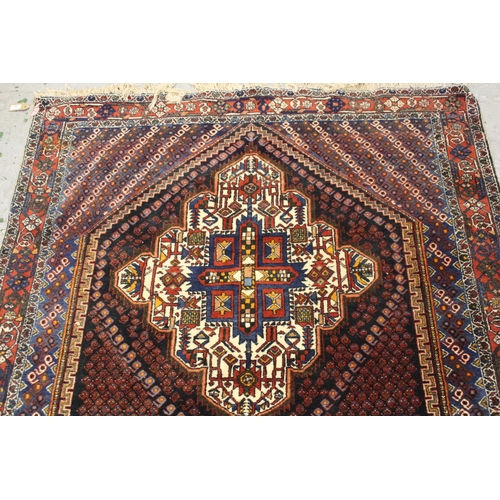 49 - Sirjan rug with a twin medallion and all-over Boteh design on a dark ground with borders and corner ... 