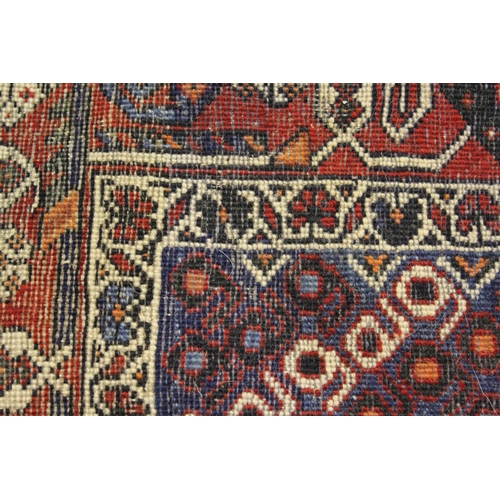 49 - Sirjan rug with a twin medallion and all-over Boteh design on a dark ground with borders and corner ... 