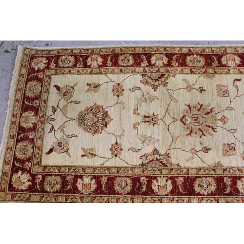 50 - Indo Persian runner of Ziegler design with a palmette pattern on an ivory ground with borders, 249cm... 