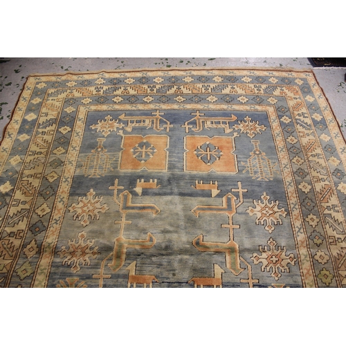 51 - Modern Turkish carpet with a geometric animal and stylised floral design on a pale blue ground with ... 