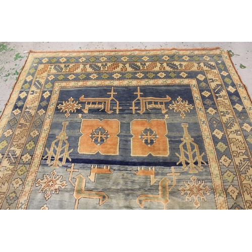 51 - Modern Turkish carpet with a geometric animal and stylised floral design on a pale blue ground with ... 