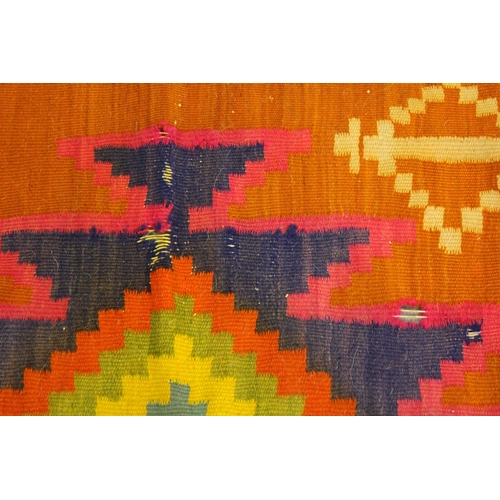 53 - Kelim rug with polychrome all-over geometric design on an orange ground, 286cms x 178cms, together w... 