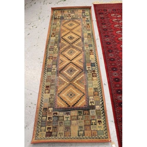 56 - Machine woven runner of Turkoman design, 2.7m x 70cms approximately, together with a similar, smalle... 