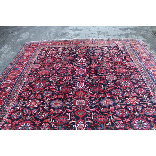 7 - Sarouk Mahal carpet with an all-over stylised flower head design, on a midnight blue ground with bor... 