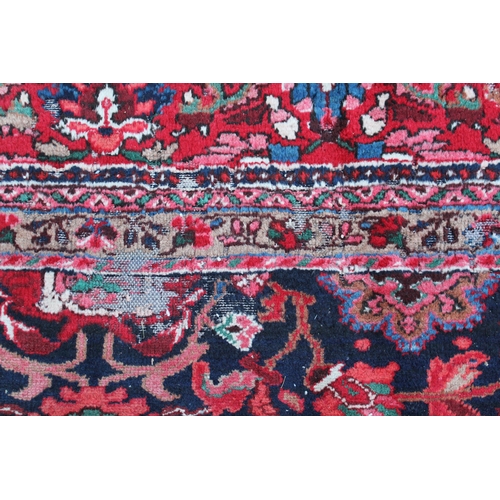 7 - Sarouk Mahal carpet with an all-over stylised flower head design, on a midnight blue ground with bor... 