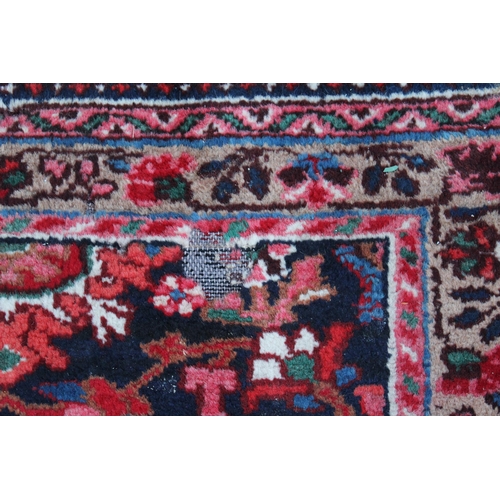 7 - Sarouk Mahal carpet with an all-over stylised flower head design, on a midnight blue ground with bor... 