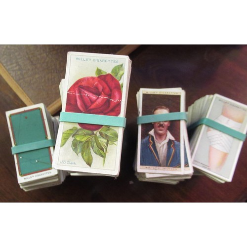 146 - Two blue boxes containing a large collection of various Wills, odd cigarette cards, including milita... 