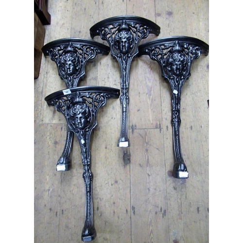 107 - Two pairs of powder coated cast iron pub table legs with mask head decoration