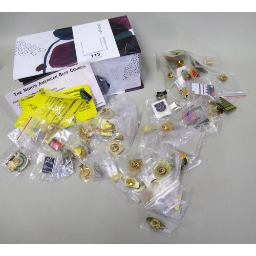 113 - Box containing a large collection of lapel pins and badges, from various commercial and political me... 