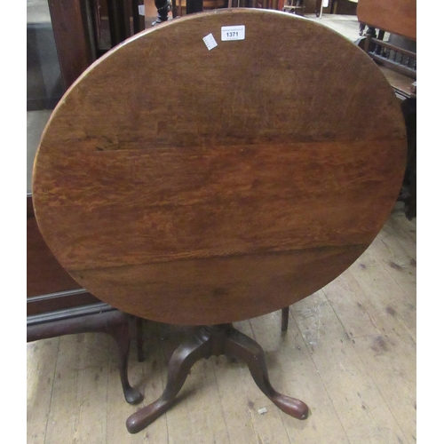 1371 - 18th Century oak circular pedestal table with a turned column support on tripod base, 79cms diameter