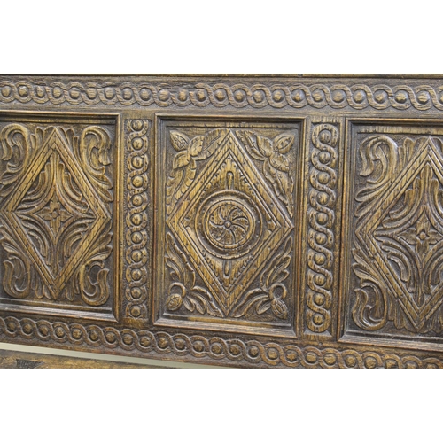 1385 - 19th / early 20th Century oak box settle, the carved three panel back above a hinged seat and three ... 