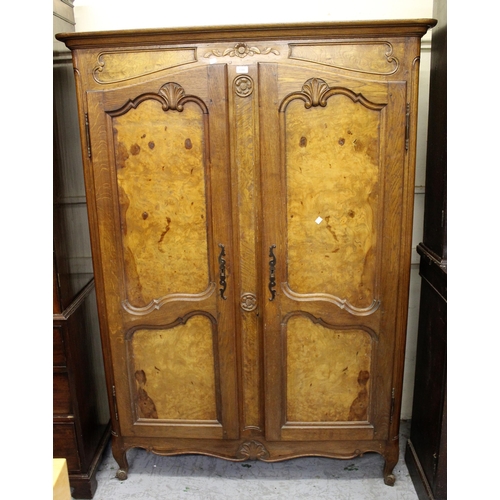 1390 - Early 20th Century French oak and burr elm armoire, the panel doors with carved decorations on cabri... 