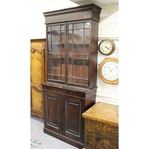 1397 - 19th Century mahogany bookcase, the moulded and carved cornice above two bar glazed doors enclosing ... 