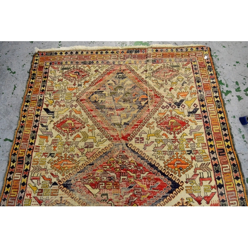 14 - Soumak rug with three central medallions and various figures of birds, with multiple borders on a cr... 