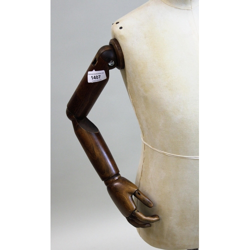 1407 - 20th Century antique style dressmaker's dummy with articulated wooden arms on metal stand