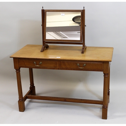 1423 - Peter Hall of Staveley, 20th Century Arts and Crafts oak two drawer dressing table on turned support... 