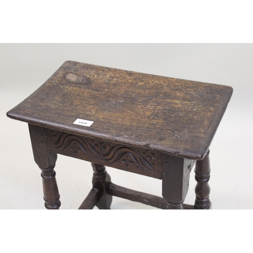 1439 - Oak joint stool, the moulded plank top above a carved frieze and baluster turned supports with stret... 